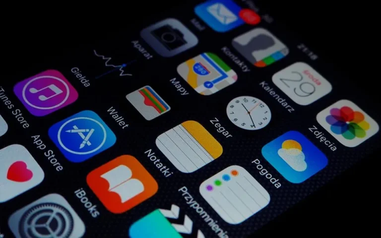 Hands holding a smartphone full of apps, illustrating how to free up phone storage