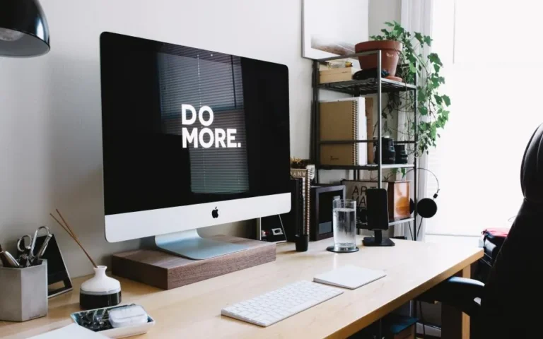 Organised desk with laptop and planner, showing tech habits that save time