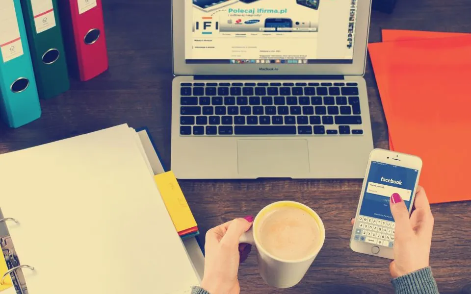Desk with a laptop, smartphone and coffee, welcoming readers to Technicalinterest.Com